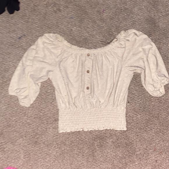 Tops - It’s a cream white color and it has buttons in the front as a design